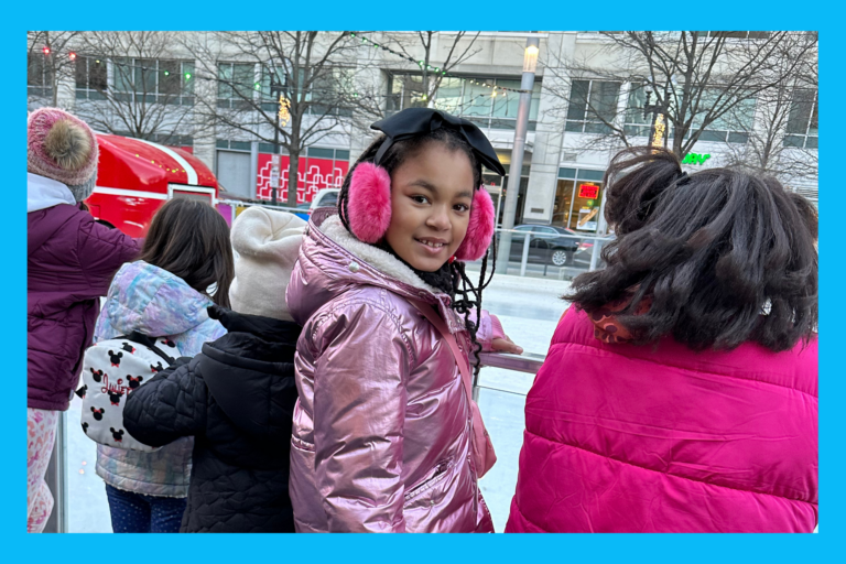 Liv standing in front of Canal Park Ice Skating Rink.
