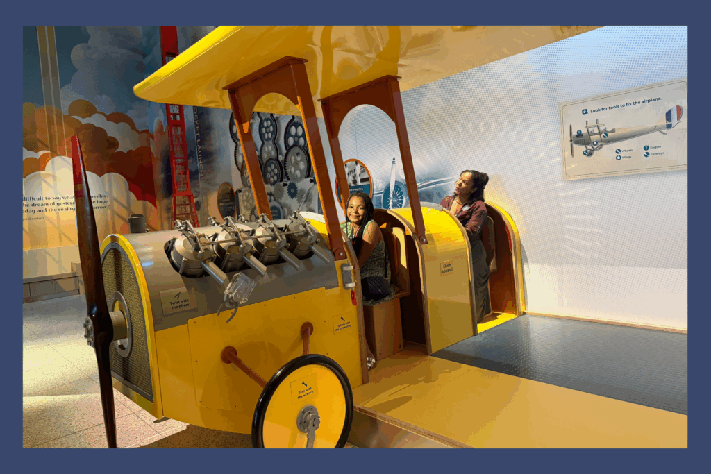 Sarah and Liv aboard a yellow plane at the National Air & Space Museum