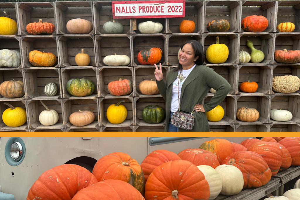 A young woman poses in front of of the pumpkin wall at Nall's produce in 2022.