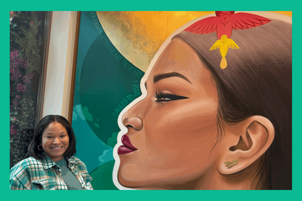 Sarah in front of artwork by Miss Che Love at the Milken Center