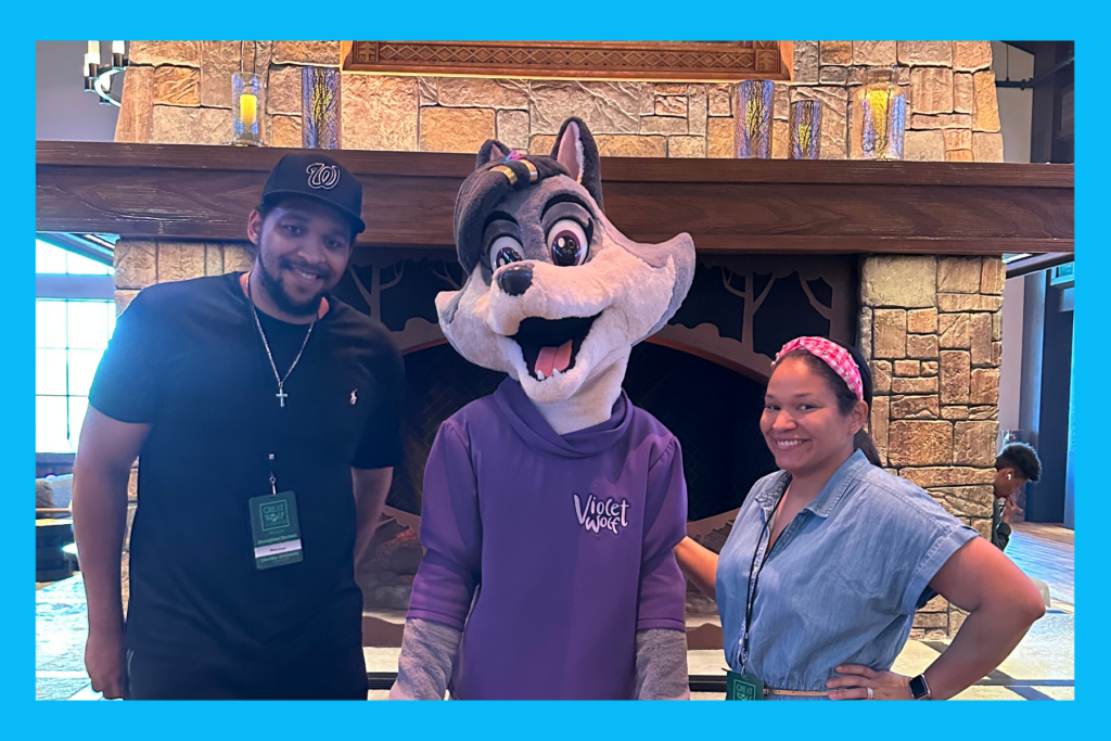 Sarah and Nate stand with Violet Wolf at the grand opening of Great Wolf Lodge Maryland