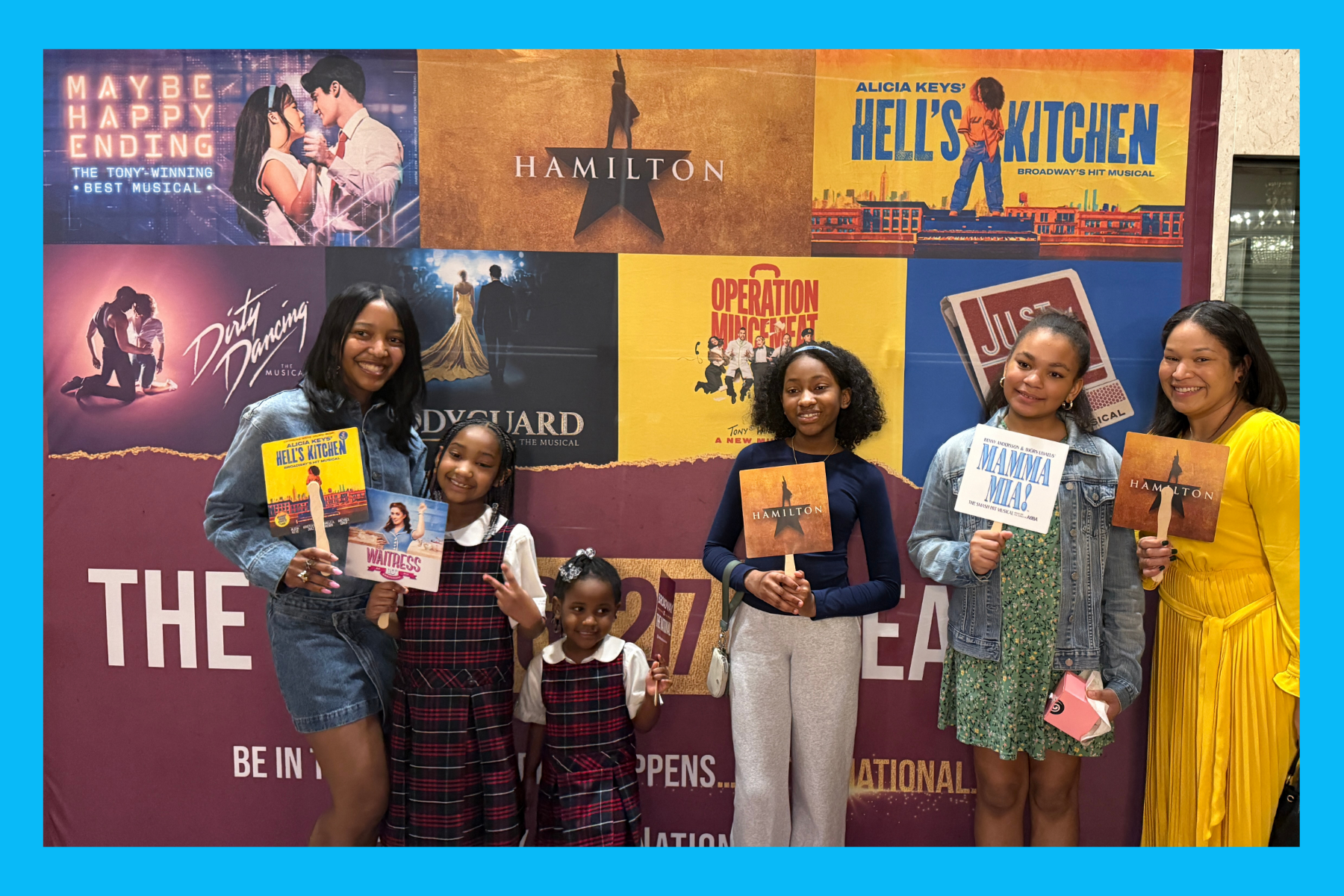 Sarah, Liv and friends stand in front of the new theatre line-up for the National Theatre