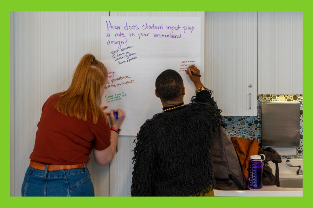 two educators write their ideas on a wipe board