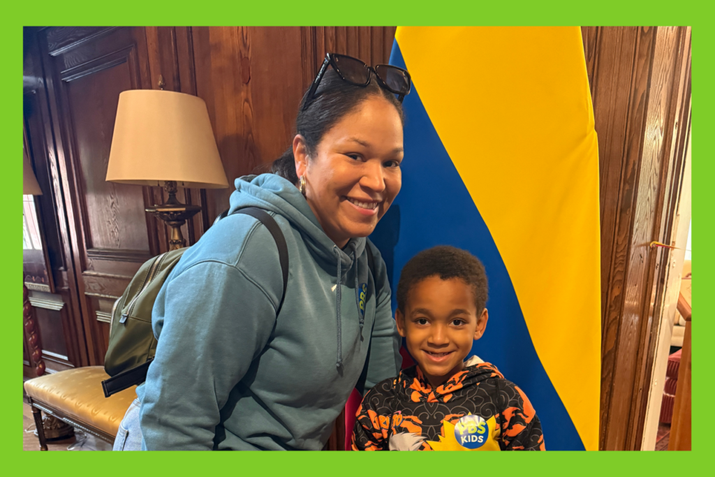 Sarah and Jack smile in front of the Colombian flag