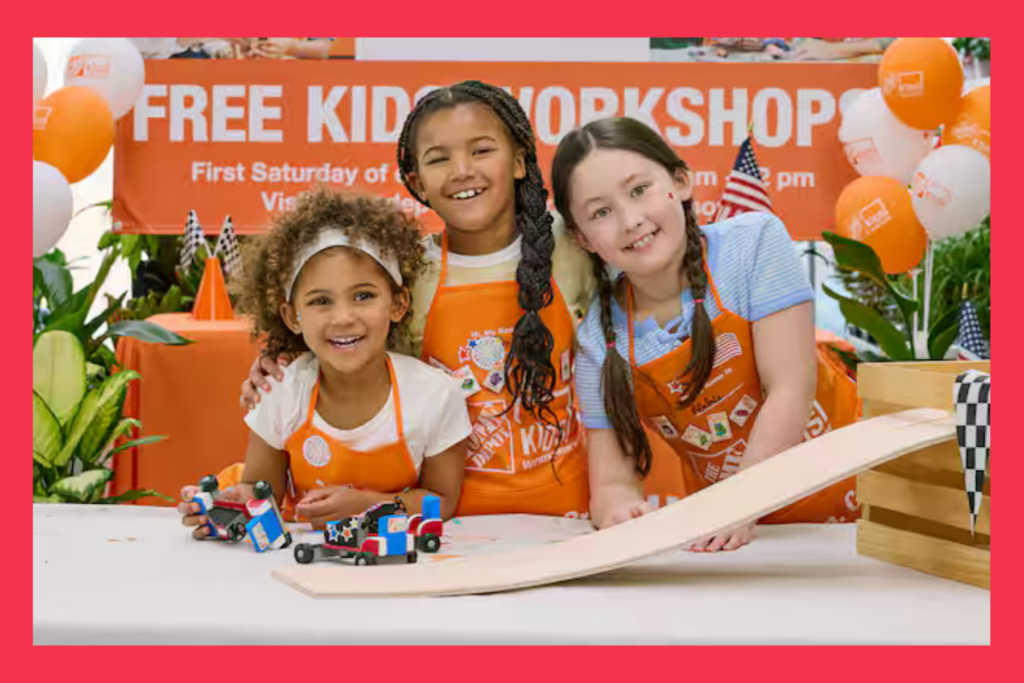 young girls huddle around a go cart in Home Depot aprons at a workshop