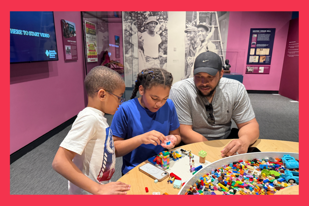 A father and two children play with legos in a colorful room at the Anacostia Community Museum