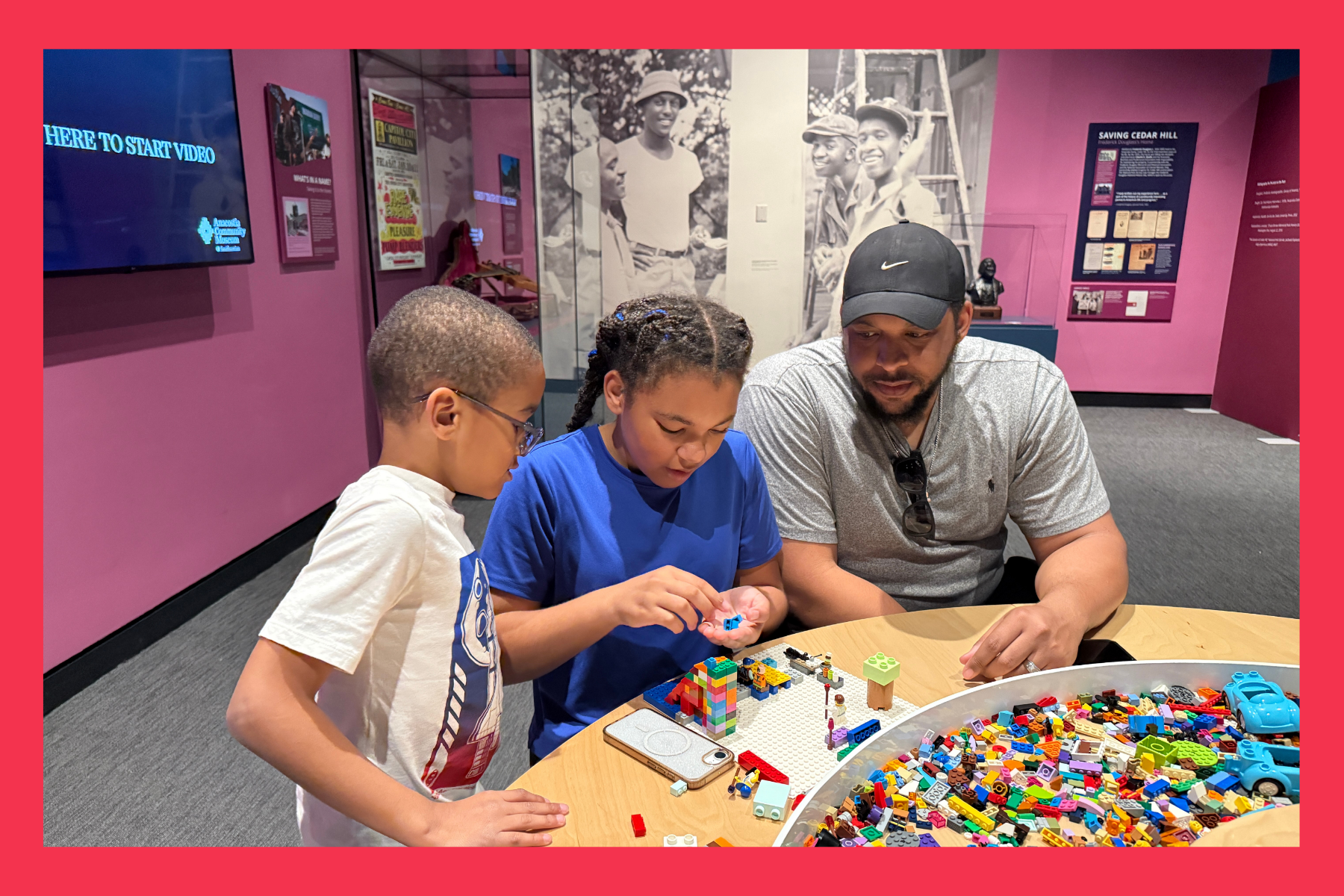 A father and two children play with legos in a colorful room at the Anacostia Community Museum