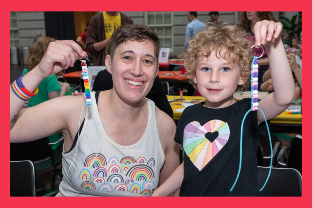 Parent and child at a pride month celebration