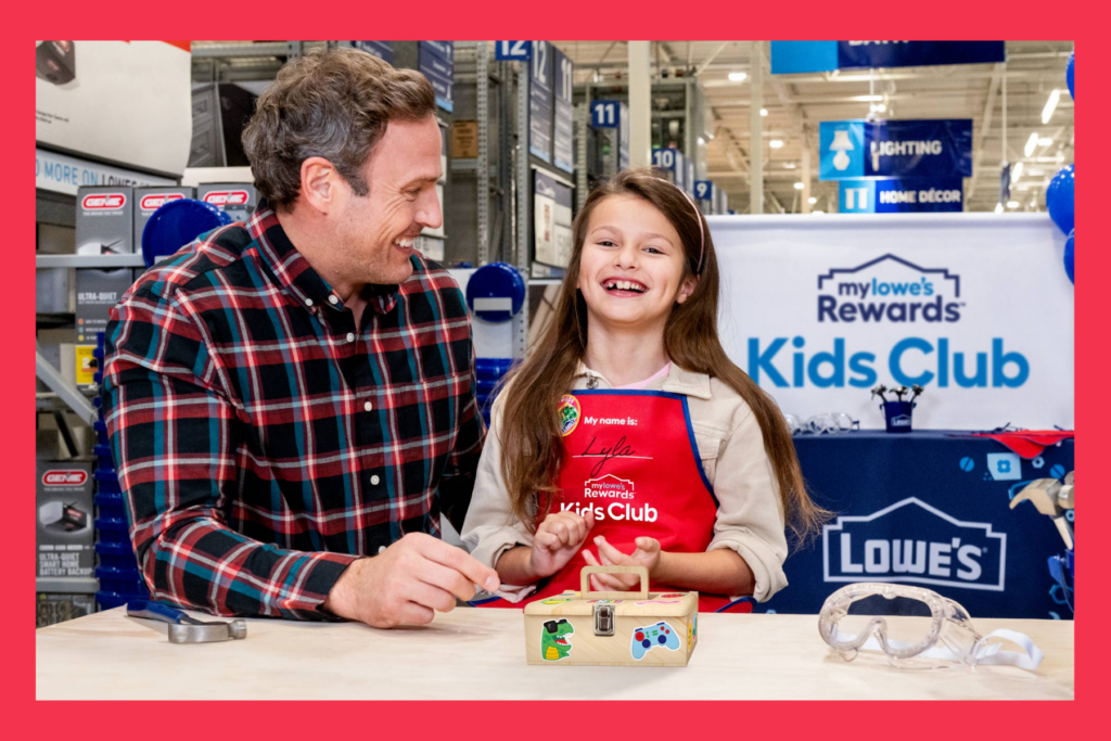 dad and daughter laugh at a Lowes Home Improvement kids workshop.