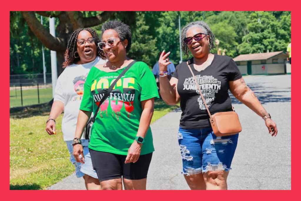 three ladies walking with Juneteenth shirts on