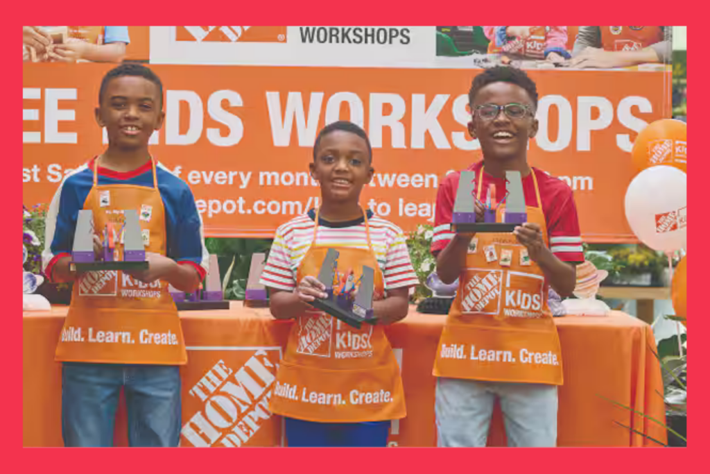 three young boys hold up their rocket games made at Home Depot stores during the monthly kids workshop.