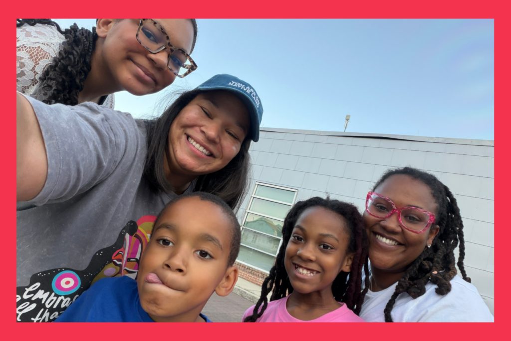 moms and kids smile on a playground.