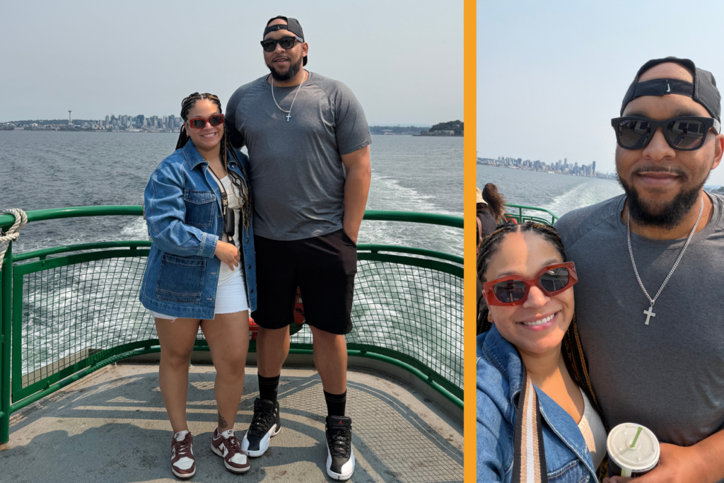 Husband and wife on a ferry to Bainbridge Island with Seattle skyline in the background.