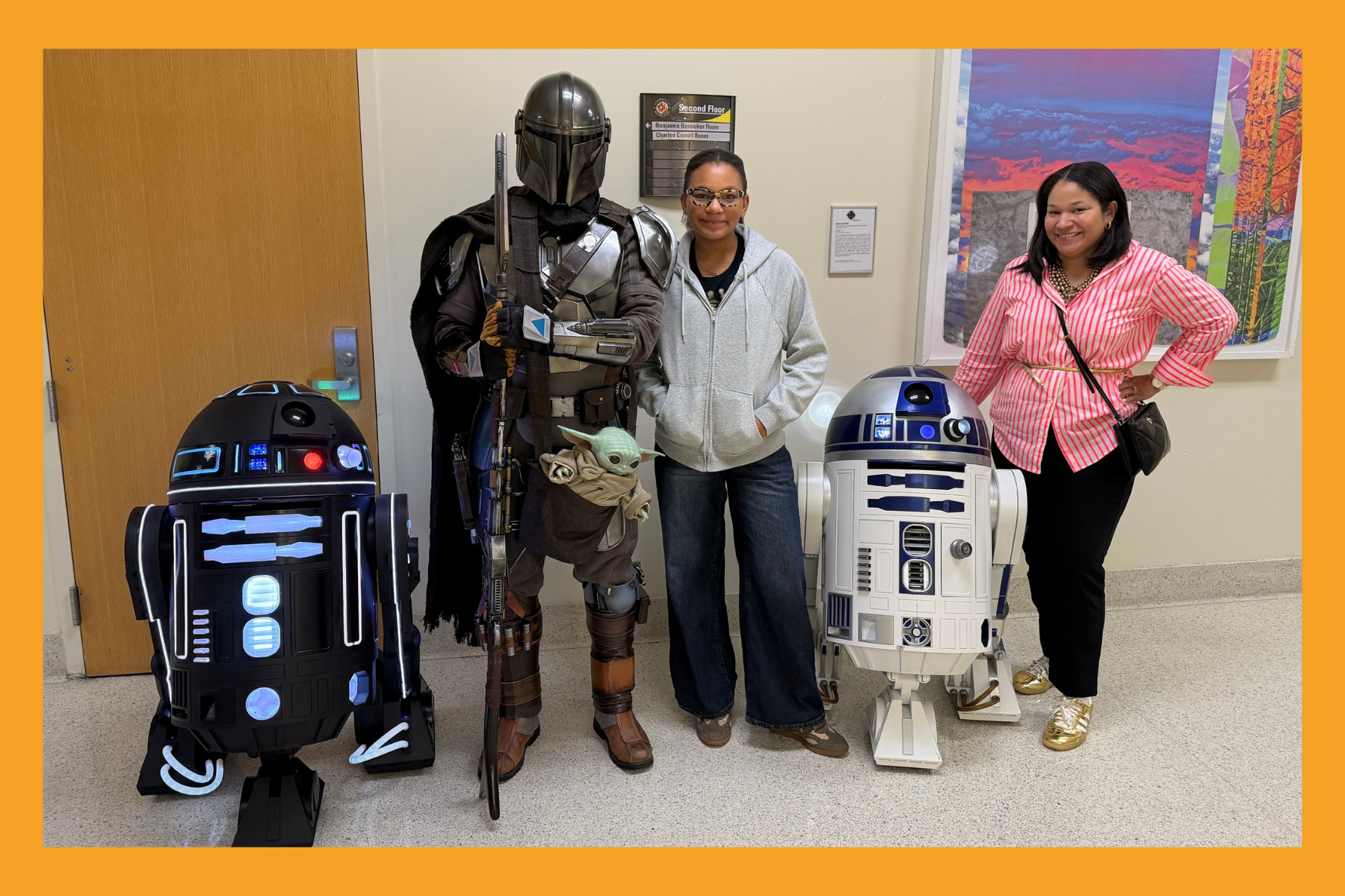 mom and daughter pose with characters from Star Wars.