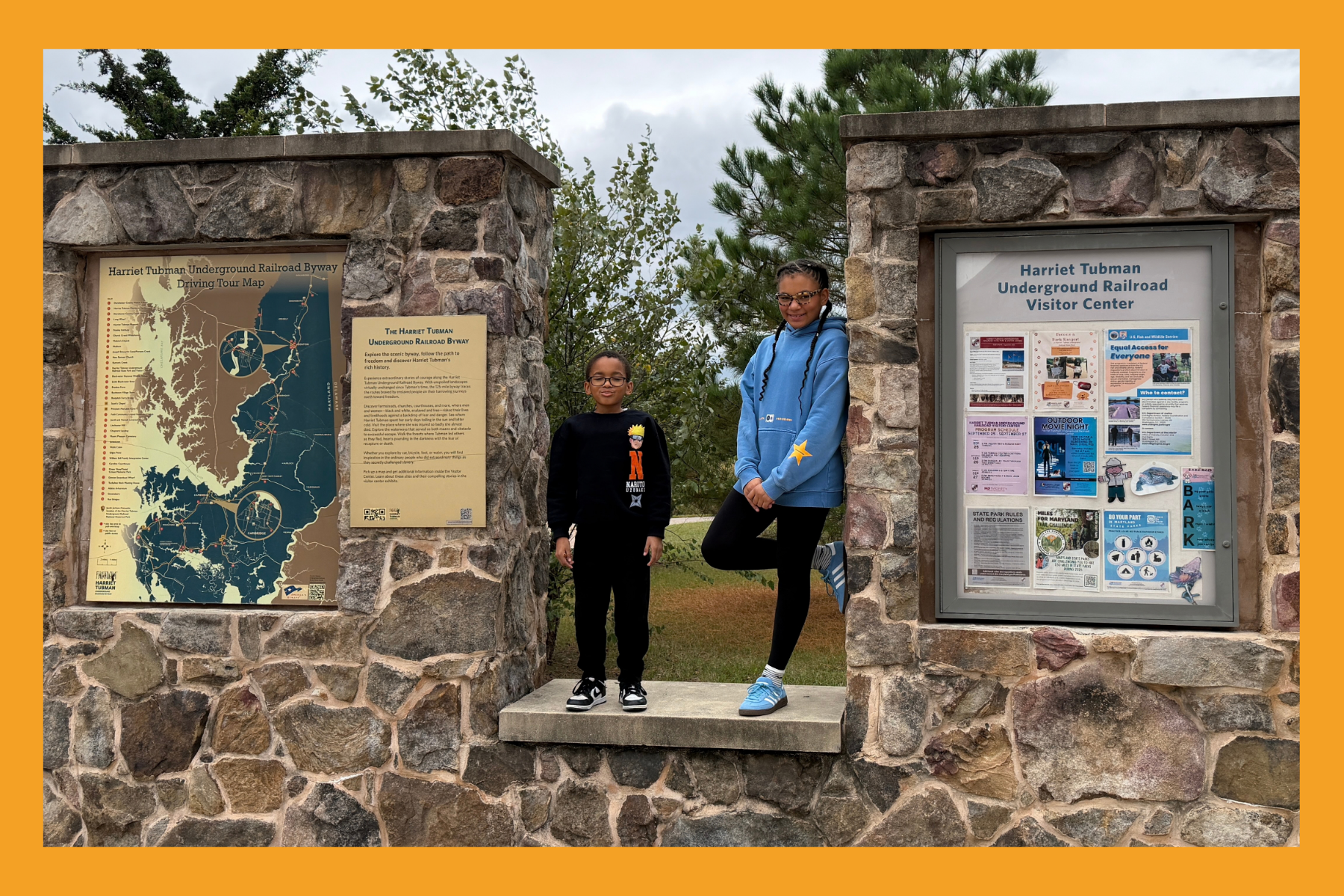 two young kids pose at the Harriet Tubman Underground Railroad byway driving tour map.