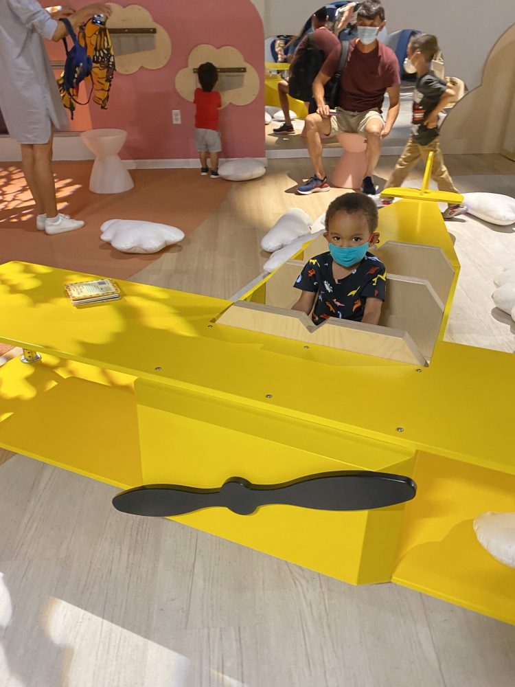 Jackson sits in an airplane at the National Children's Museum.